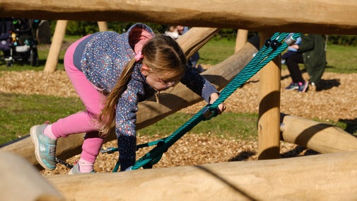 A young visitor enjoying the new farm playground at Wimpole Estate